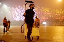 Brother Nut walks around Beijing sucking up air pollution into a vacuum. 