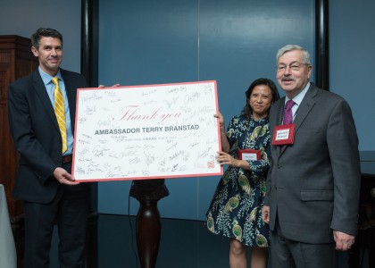 Travis Tanner, President of The US-China Strong Foundation & Holly Chang, Founder of Project Pengyou, present Ambassador Branstad with a signed gift from all the guests.